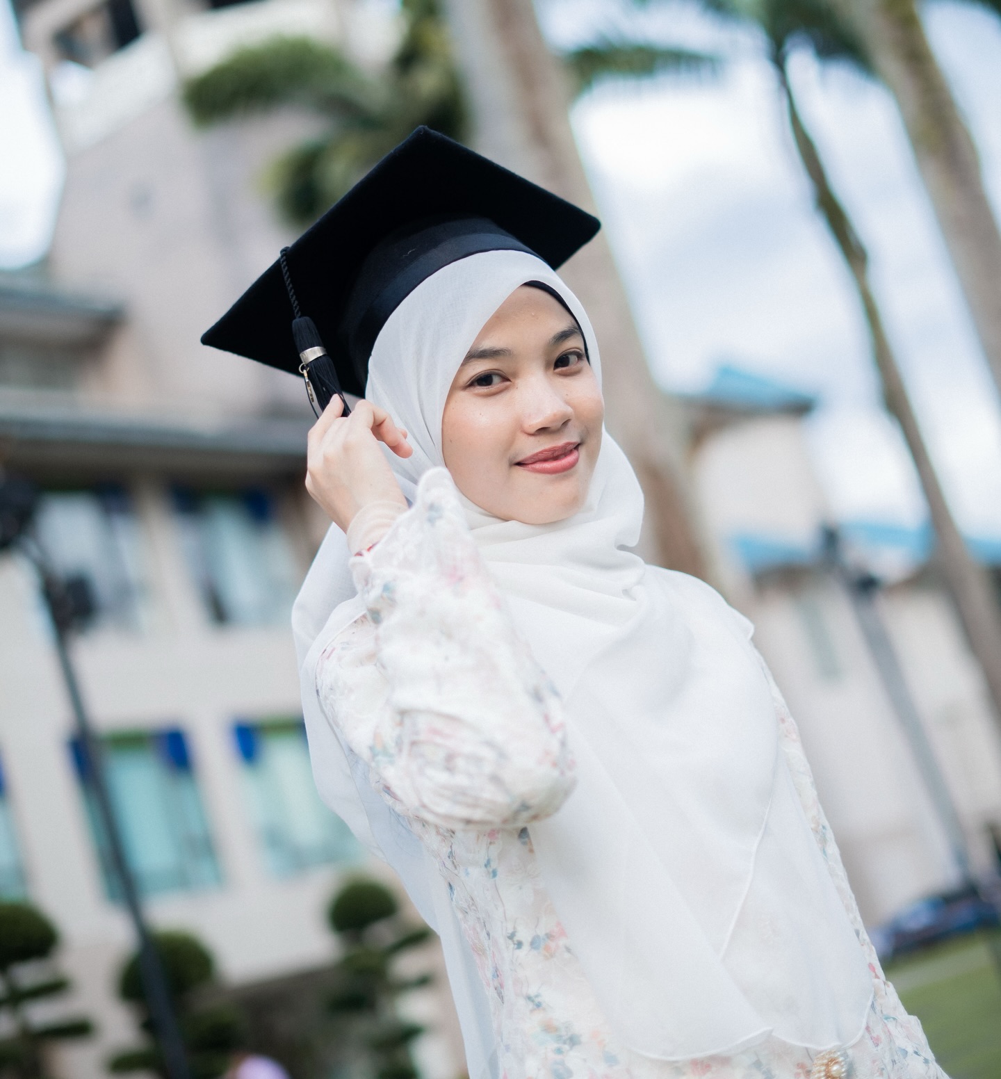 Afisah in her graduation cap and attire